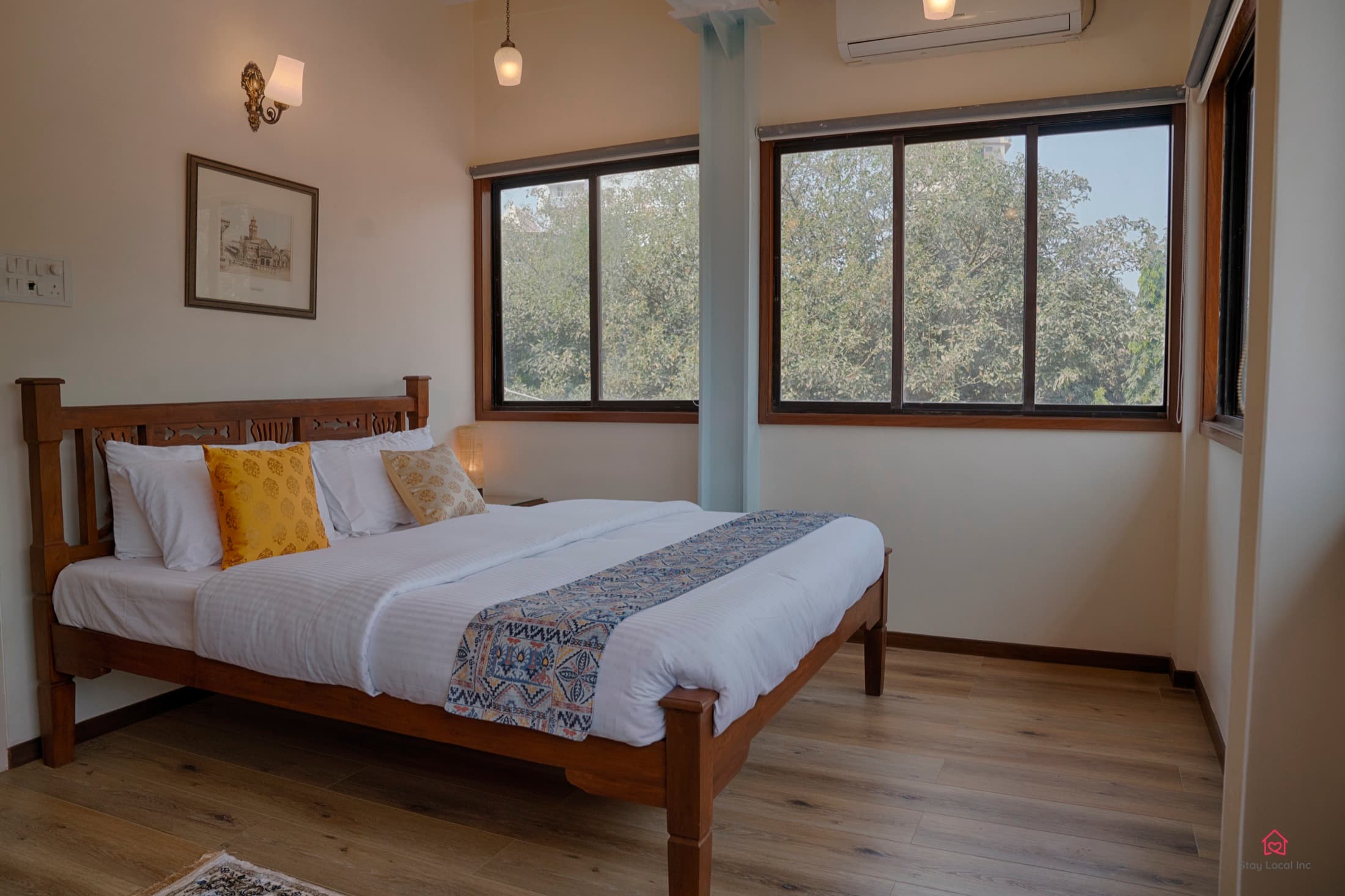 Double bedroom with tree-facing windows near Blue Co-Labs